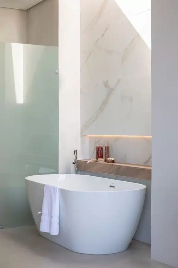 Modern bathroom with freestanding tub and marble wall design